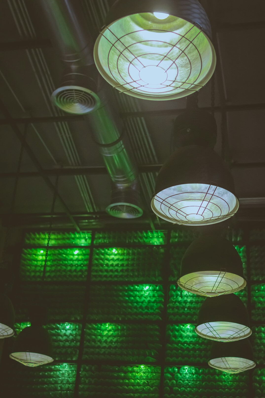 Overhead studio lighting grid with LED panels and fresnel lamps