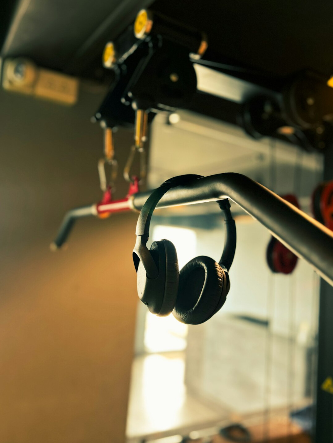Studio microphones on boom arms above a desk with headphones