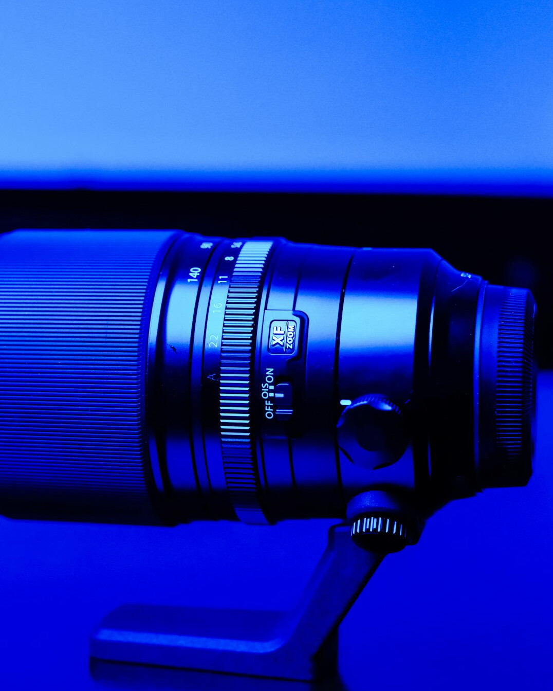 Close-up of a broadcast studio camera lens on a pedestal